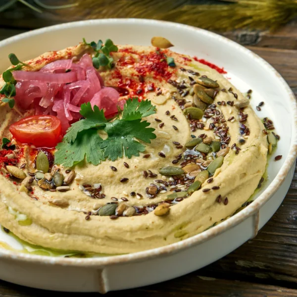 classic-oriental-appetizer-chickpea-hummus-white-plate-wooden-close-up