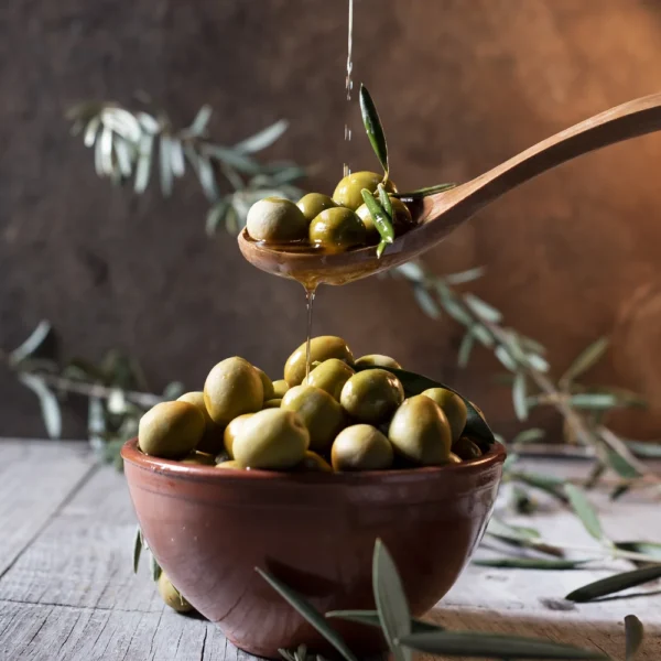 olives-wooden-spoon-pouring-oil-bowl-full-olives-with-bone