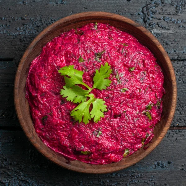 top-view-beet-salad-with-walnut-mayyonaise-dark-desk.webp