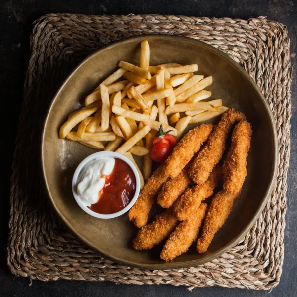 top-view-chicken-nuggets-with-french-fries-tomato-sous-clay-dishes