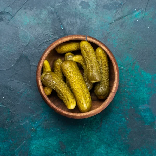 top-view-salty-pickles-inside-round-brown-pot-dark-blue-surface (1)